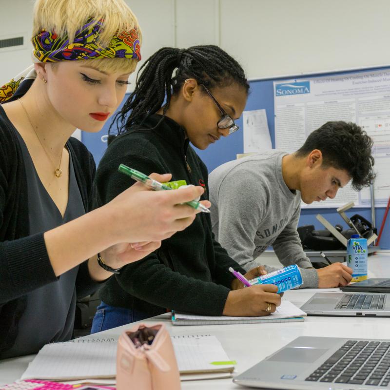 Students read nutritional information labels and take notes